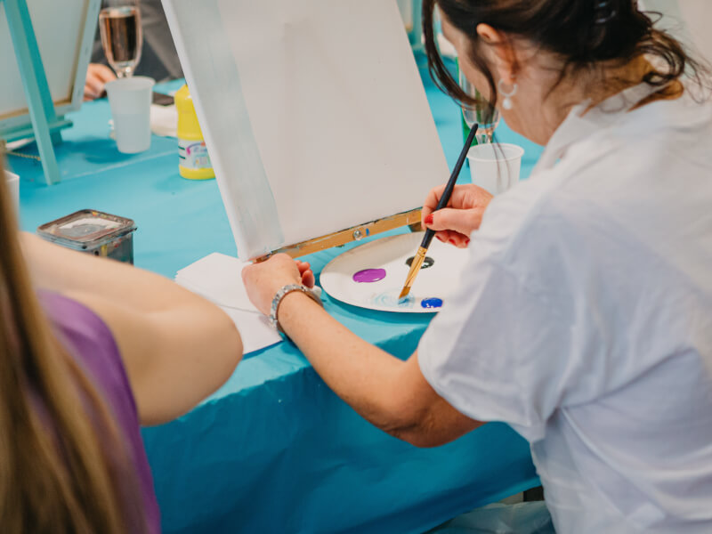 A lady learning how to paint.